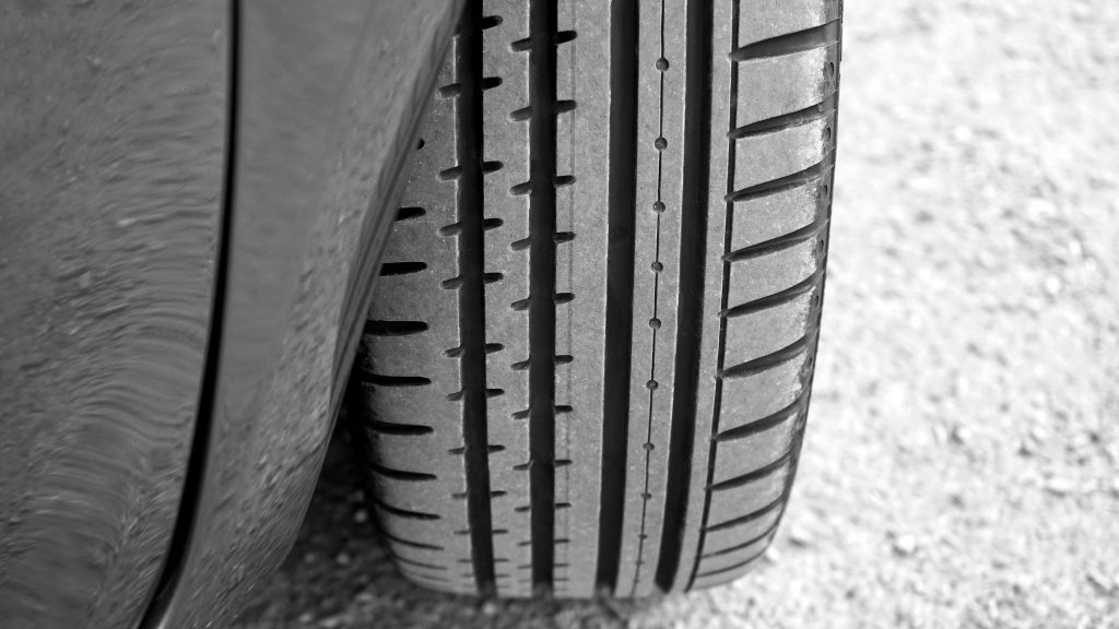 pexels photo 441103 441103 Detailed view of vehicle tire on a gravel surface, showcasing tread pattern.