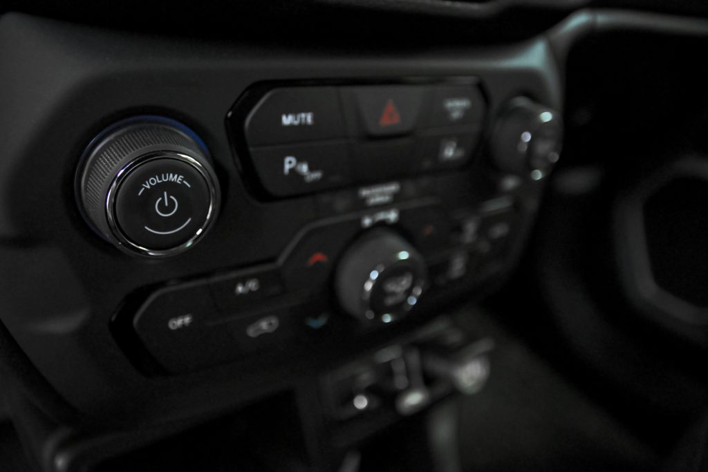 pexels photo 8315429 8315429 Detailed view of car dashboard featuring volume, AC, and power controls in a luxury vehicle.
